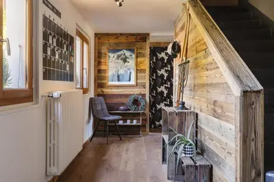 a staircase in a house with a wooden wall at Chalet Benoit - Modern Chalet 8 Pax Free Parking Mountain View - By Cozee Rentals in Chamonix-Mont-Blanc