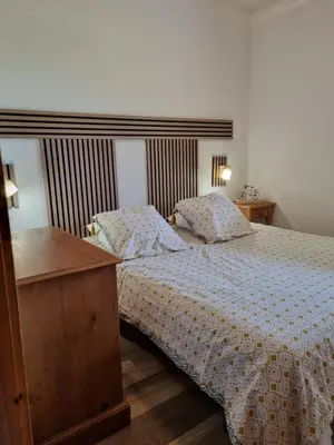 a bedroom with a bed and a wooden dresser at LE GRAND TETRAS in Samoëns