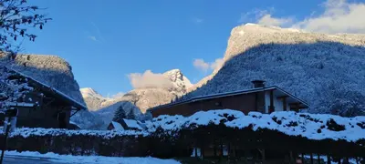a house with snow on it in front of a mountain at LE GRAND TETRAS in Samoëns