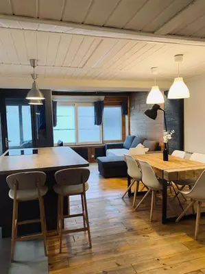 a living room with a couch and a table and chairs at Bel appartement familial et cosy in Saint-Gervais-les-Bains