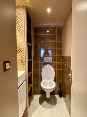a small bathroom with a toilet and a sink at Bel appartement familial et cosy in Saint-Gervais-les-Bains