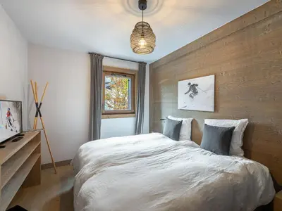 a bedroom with a large white bed and a window at Appartement cosy à Rochebrune, piscine et parking - FR-1-569-58 in Megève