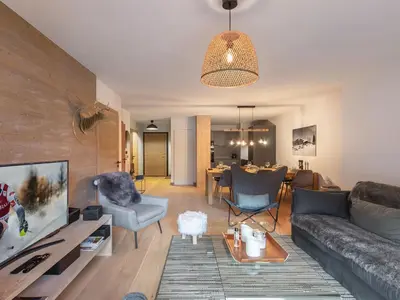 a living room with a couch and chairs and a tv at Appartement cosy à Rochebrune, piscine et parking - FR-1-569-58 in Megève