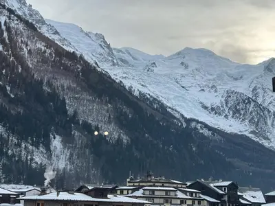 a town in front of a snow covered mountain at STUDIO DENT DU CAIMAN, CHAMONIX hyper CENTRE, PARKING, VUE MONT BLANC in Chamonix-Mont-Blanc