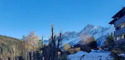 a view of a mountain with snow and trees at Le Goûter - Ski-in ski-out - Indoor Pool in Les Houches
