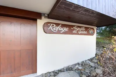 a garage door with a sign that reads refuge adaptive oil garage at Le Goûter - Ski-in ski-out - Indoor Pool in Les Houches