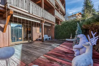 a house with a patio with reindeer statues on it at Le petit cœur de Megève -Mont770- in Megève