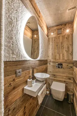 a bathroom with a sink and a toilet and a mirror at Le petit cœur de Megève -Mont770- in Megève