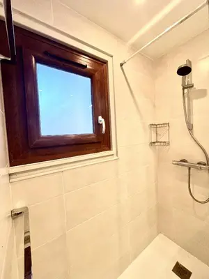 a bathroom with a shower and a window at Le Chaney - T2 dans chalet - Massif du Mont-Blanc in Chamonix-Mont-Blanc