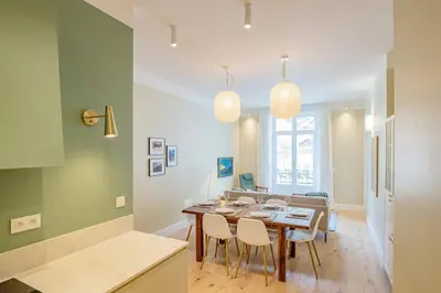a kitchen and dining room with a table and chairs at Majestic Alpin - A luxurious apartment with a nordic feel in Chamonix-Mont-Blanc