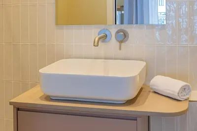 a white sink on a counter in a bathroom at Majestic Alpin - A luxurious apartment with a nordic feel in Chamonix-Mont-Blanc