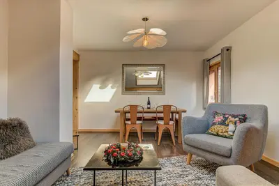 a living room with a couch and a table at Apartment Rebats - Alpes Travel - Central Chamonix in Chamonix-Mont-Blanc