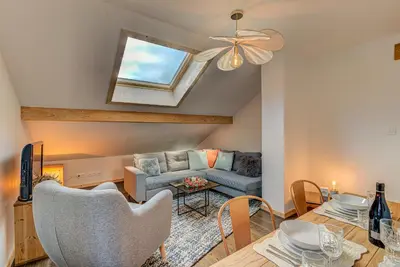 a living room with a couch and a table at Apartment Rebats - Alpes Travel - Central Chamonix in Chamonix-Mont-Blanc