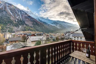 a balcony with a view of a town and mountains at Apartment Rebats - Alpes Travel - Central Chamonix in Chamonix-Mont-Blanc