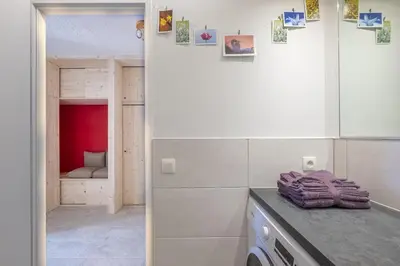 a kitchen with a counter and a room with a closet at Studio a l’aiguille du Midi in Chamonix-Mont-Blanc