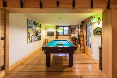 a hallway with a pool table in a house at Les Mules in Combloux