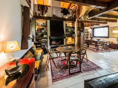 a living room with a table and a couch at Les Mules in Combloux