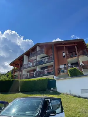 a building with a car parked in front of it at Studio montagne Demi Quartier in Demi-Quartier