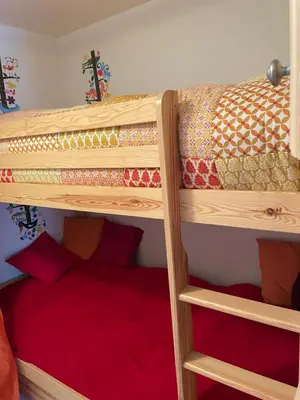 a bunk bed in a room with a bunk bed gmaxwell gmaxwell gmaxwell gmaxwell gmaxwell gmaxwell at Studio montagne Demi Quartier in Demi-Quartier