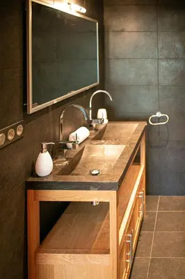 a bathroom with a sink and two faucets at Les Ecureuils -Rénové 100m2 - 8per - Skis aux Pieds - Vue sur la Montagne in Les Houches