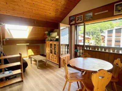 a dining room with a table and a window at T3 Appartement haute-Savoie Carroz in Les Carroz d'Araches