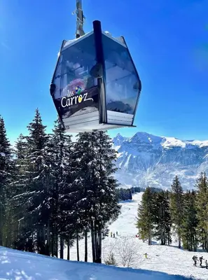a ski lift in the air over a snow covered mountain at T3 Appartement haute-Savoie Carroz in Les Carroz d'Araches