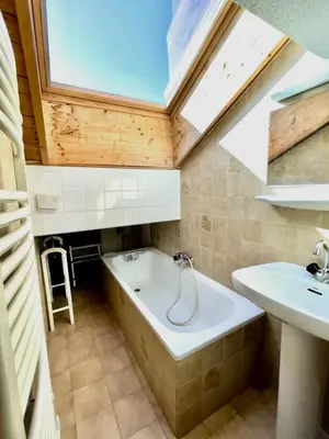 a bathroom with a bath tub and a sink at T3 Appartement haute-Savoie Carroz in Les Carroz d'Araches