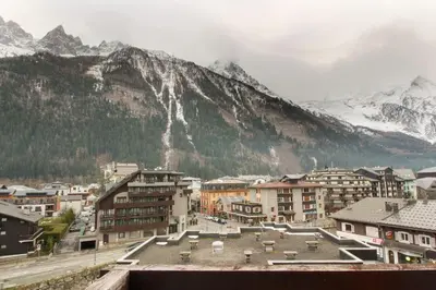 a city with buildings and a mountain in the background at L'Aiguille - Center of Chamonix - View Mont-Blanc in Chamonix-Mont-Blanc