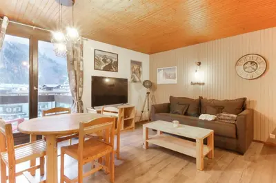 a living room with a couch and a table at L'Aiguille - Center of Chamonix - View Mont-Blanc in Chamonix-Mont-Blanc