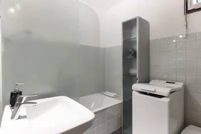 a white bathroom with a sink and a toilet at L'Aiguille - Center of Chamonix - View Mont-Blanc in Chamonix-Mont-Blanc
