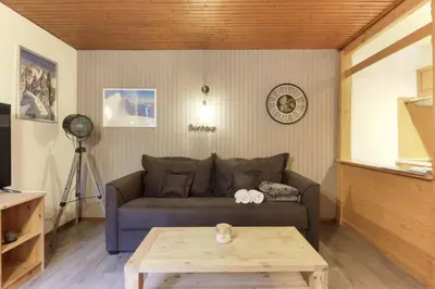 a living room with a couch and a table at L'Aiguille - Center of Chamonix - View Mont-Blanc in Chamonix-Mont-Blanc