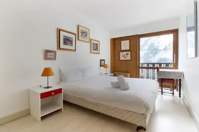 a bedroom with a large white bed and a window at Makalu - View Mont-Blanc - Chamonix Center -8 pers in Chamonix-Mont-Blanc