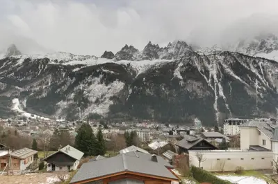 a town with a mountain in the background with snow at Makalu - View Mont-Blanc - Chamonix Center -8 pers in Chamonix-Mont-Blanc