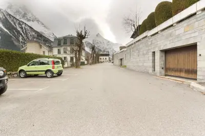 an empty street with a car parked in a parking lot at Makalu - View Mont-Blanc - Chamonix Center -8 pers in Chamonix-Mont-Blanc