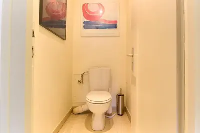 a small bathroom with a toilet and paintings on the wall at Makalu - View Mont-Blanc - Chamonix Center -8 pers in Chamonix-Mont-Blanc