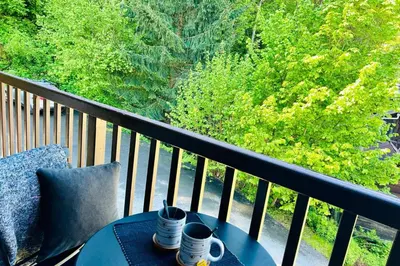 two cups of coffee on a table on a balcony at Apt with nice view near the center of Chamonix in Chamonix-Mont-Blanc