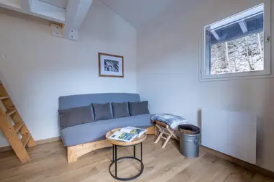 a living room with a couch and a table at Apt with nice view near the center of Chamonix in Chamonix-Mont-Blanc