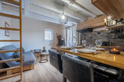 a kitchen and dining room with a long table and chairs at Apt with nice view near the center of Chamonix in Chamonix-Mont-Blanc