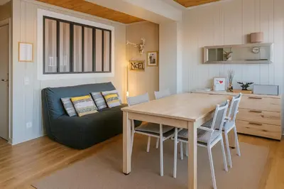 a dining room with a table and a couch at White Lodges - Megève center on ski slopes in Megève