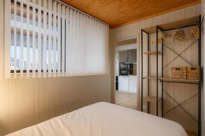 a bedroom with a bed and a window at White Lodges - Megève center on ski slopes in Megève