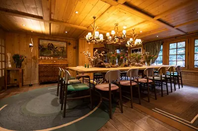 a dining room with a long table and chairs at Magic Megève Bois in Demi-Quartier