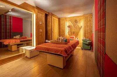 a bedroom with a large bed and a mirror at Magic Megève Bois in Demi-Quartier