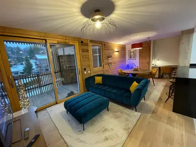 a living room with a couch and a table at les Airelles 202 in Les Carroz d'Araches