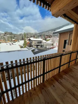 a balcony with a view of the snow covered mountains at les Airelles 202 in Les Carroz d'Araches