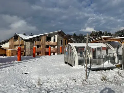 a building in the snow with a tent at les Airelles 202 in Les Carroz d'Araches