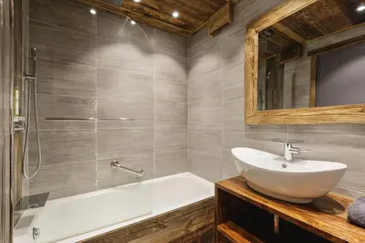 a bathroom with a sink and a tub and a mirror at Le Nid d'Aigle - Modern Apartment Next to Ski lift Prarion - By Cozee Rentals in Les Houches