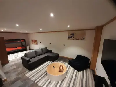 a living room with a couch and a table at Chalet Isabella by Brennus Chamonix in Chamonix-Mont-Blanc