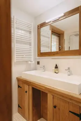 a bathroom with a white sink and a mirror at Chalet Isabella by Brennus Chamonix in Chamonix-Mont-Blanc