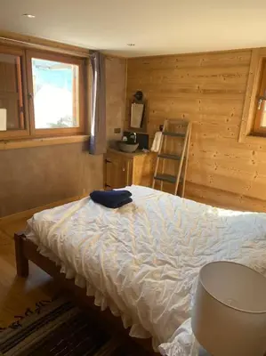 a bedroom with a bed and a ladder in it at Chalet Isabella by Brennus Chamonix in Chamonix-Mont-Blanc