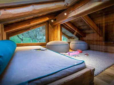 a bed in a tiny house with a window at Chalet Beau Caillou - OVO Network in Saint-Gervais-les-Bains